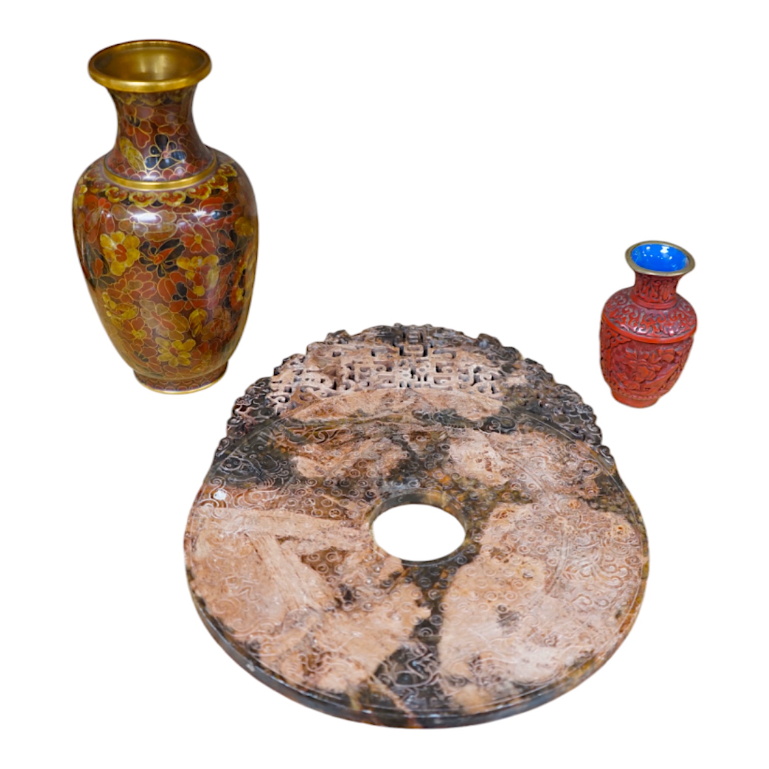 A Chinese archaistic hardstone large bi disc, a cinnabar lacquer vase and a cloisonné enamel vase, largest 32cm high (3). Condition - fair to good